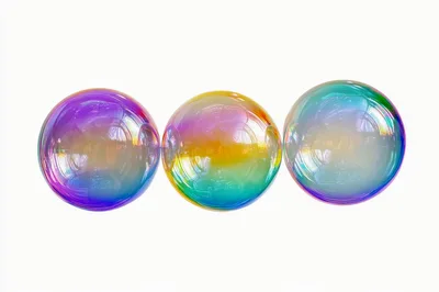 Three Iridescent Soap Bubbles Floating Against White Background