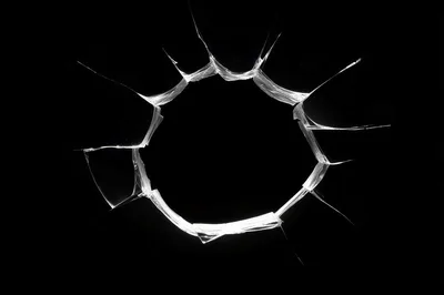 Shattered Glass Hole Isolated On Black Background