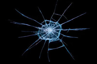Shattered Glass Texture With Radial Cracks On Black Background