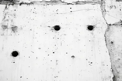 Textured Concrete Wall With Circular Drill Holes