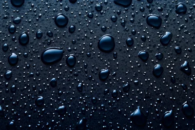 Water Droplets On A Dark Textured Surface