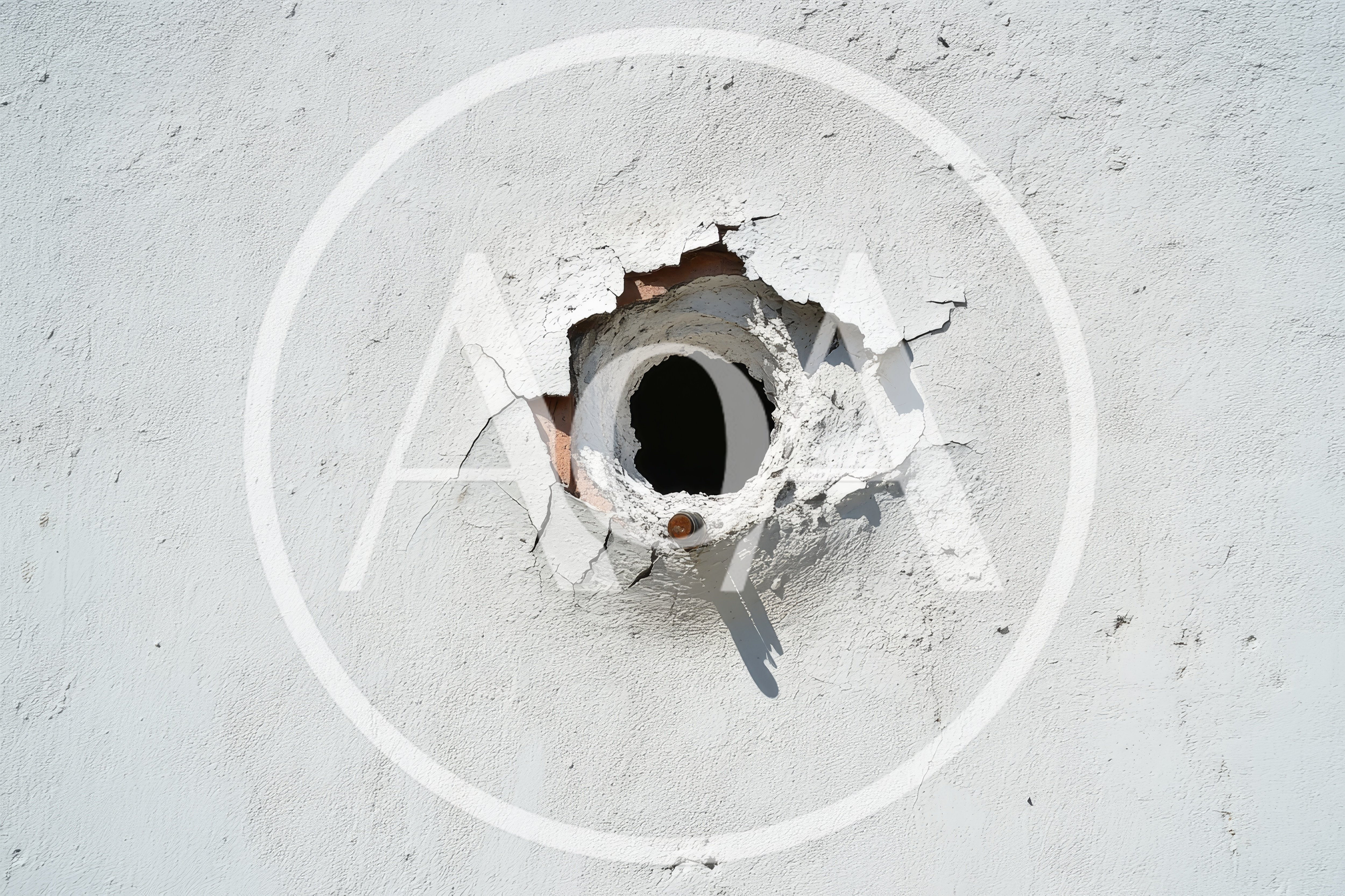 Damaged White Stucco Wall With Circular Hole