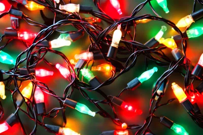 Colorful Christmas String Lights Tangled On Dark Background