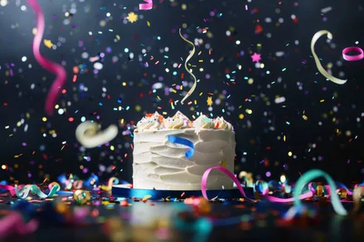 Celebratory Birthday Cake With Falling Confetti And Streamers