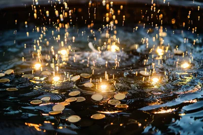 Gold Coins Tossed Into A Wishing Fountain