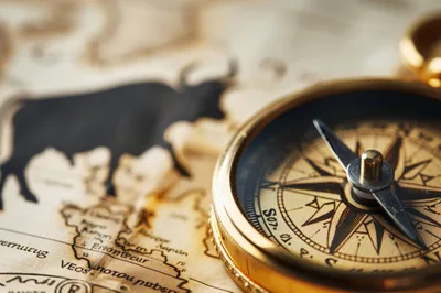 Vintage Brass Compass Resting On An Antique Map