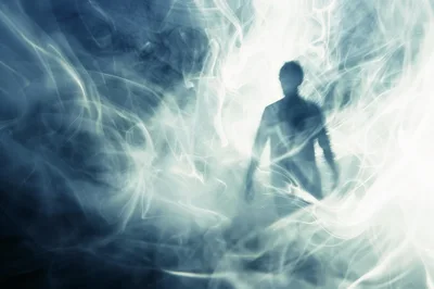 Ethereal Human Silhouette Emerging From Swirling Blue Smoke