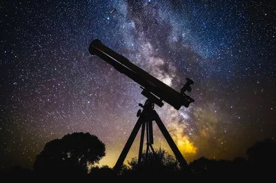 Telescope Silhouetted Against The Milky Way Galaxy