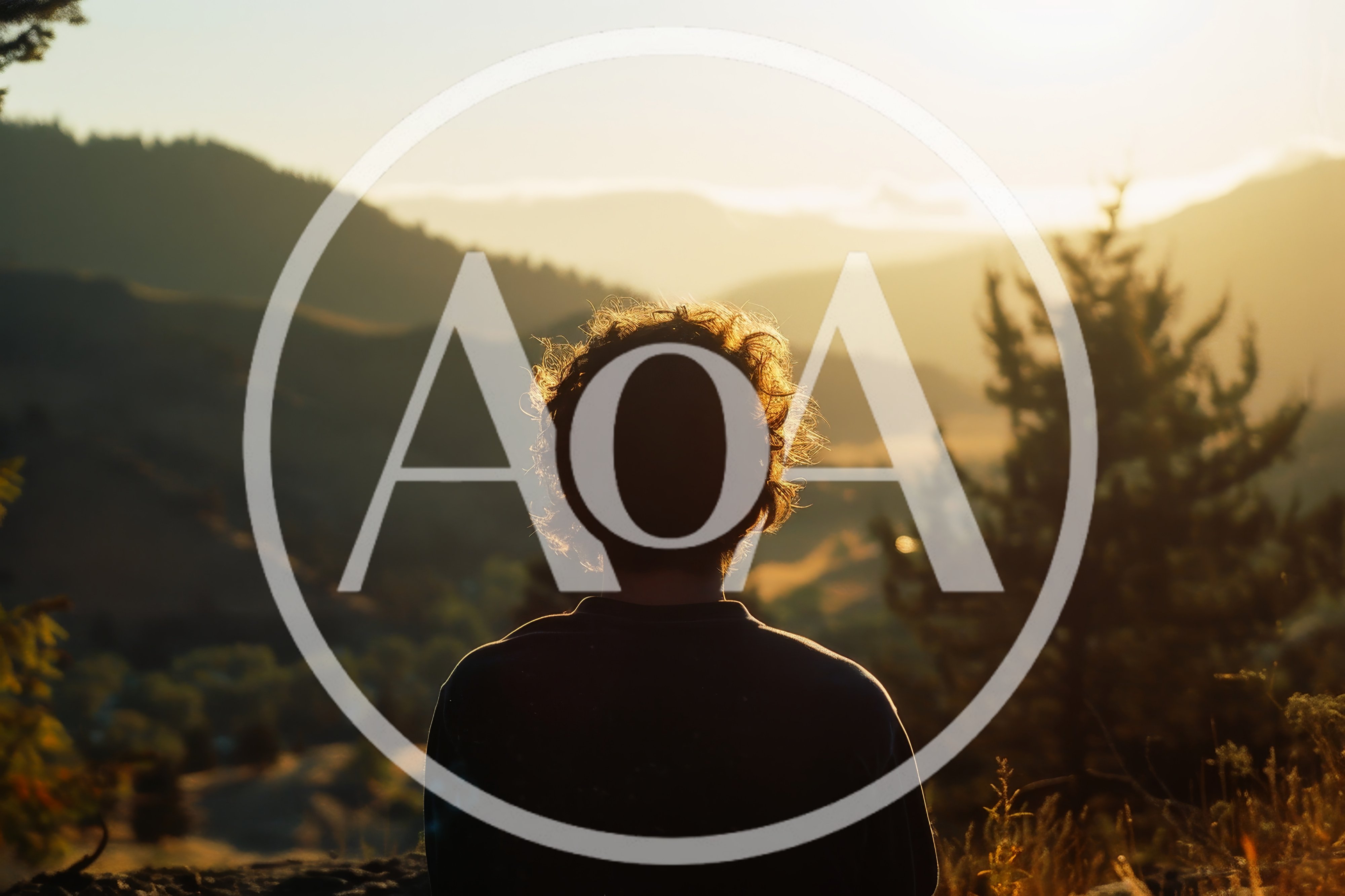 Person Looking At Sunset Over Mountain Landscape