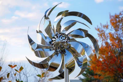 Reflective Metal Wind Spinner Sculpture in Autumn Garden