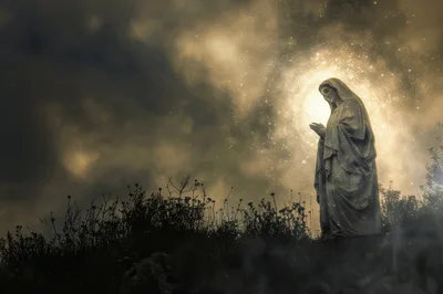 Statue Of The Virgin Mary In A Mystical Landscape