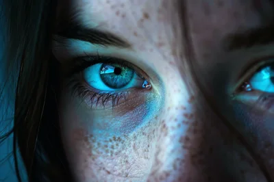 Extreme Close Up Of A Woman With Glowing Blue Eyes