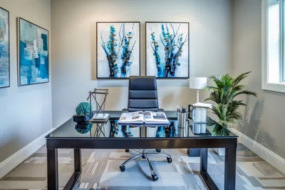 Modern Home Office With Black Desk And Abstract Art