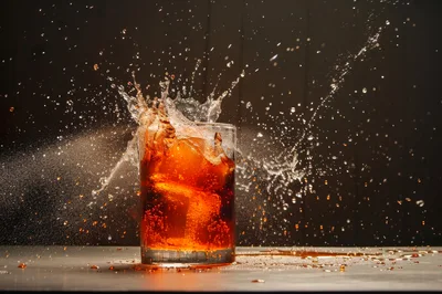 Dynamic Cola Splash in Glass with Ice Cubes