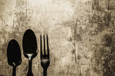 Black Cutlery Set On A Distressed Textured Surface