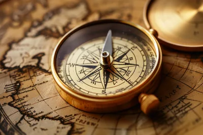 Vintage Brass Compass Resting On An Antique Map
