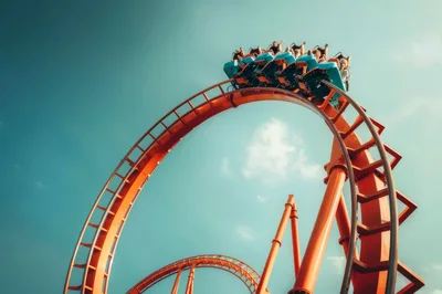 Roller Coaster Train Inverted Loop Against Blue Sky