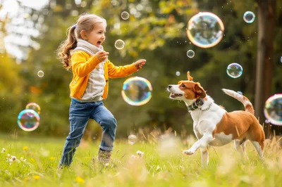 Little Girl Playing With Her Dog And Bubbles