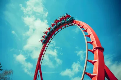 Roller Coaster Train Inverted Loop Against Blue Sky