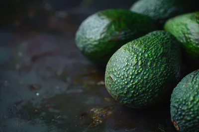 Fresh Ripe Avocados on a Dark Rustic Surface