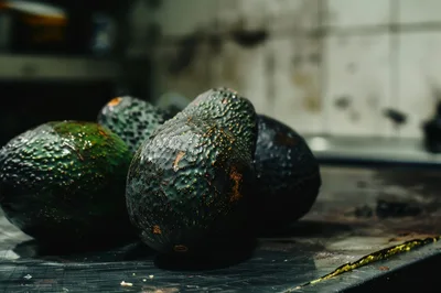 Fresh Ripe Avocados Resting On A Kitchen Counter