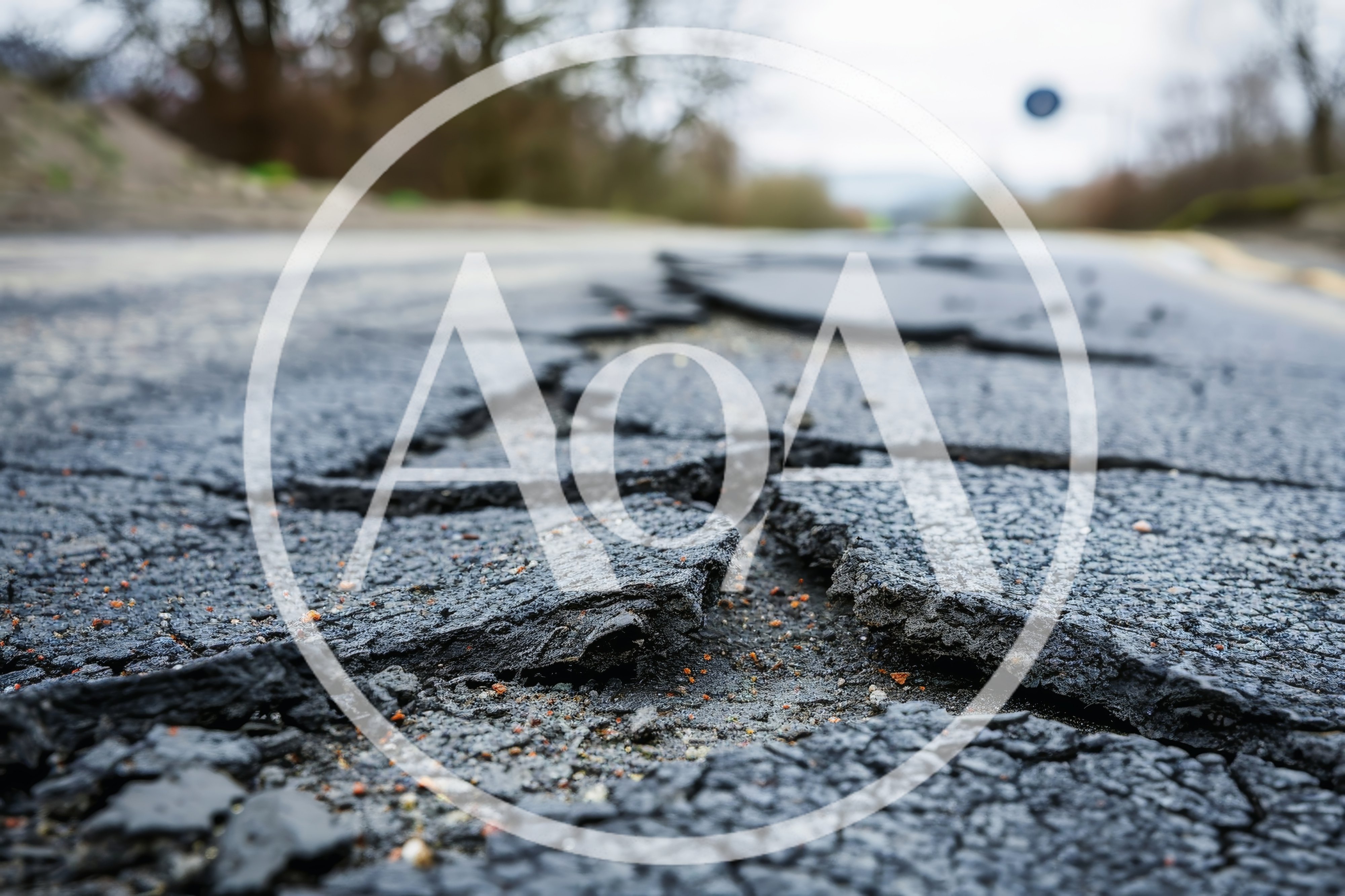 Damaged Asphalt Road Surface With Deep Cracks