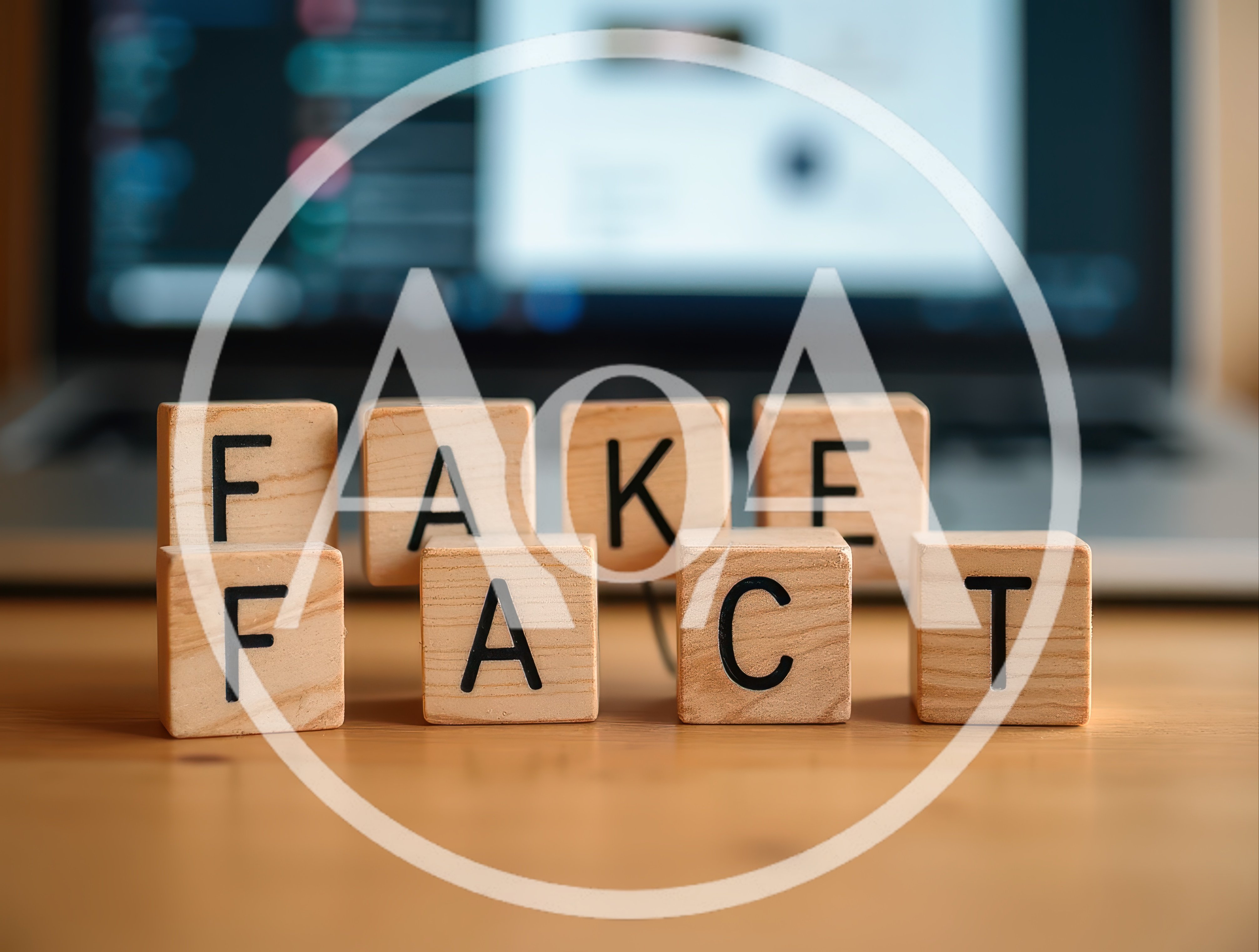 Wooden Blocks Spelling Fake Fact On Office Desk