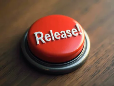 Red Release Button On A Wooden Desk