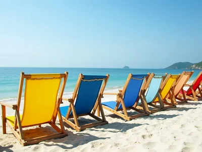 Colorful Beach Chairs Lined Up On Tropical Sand