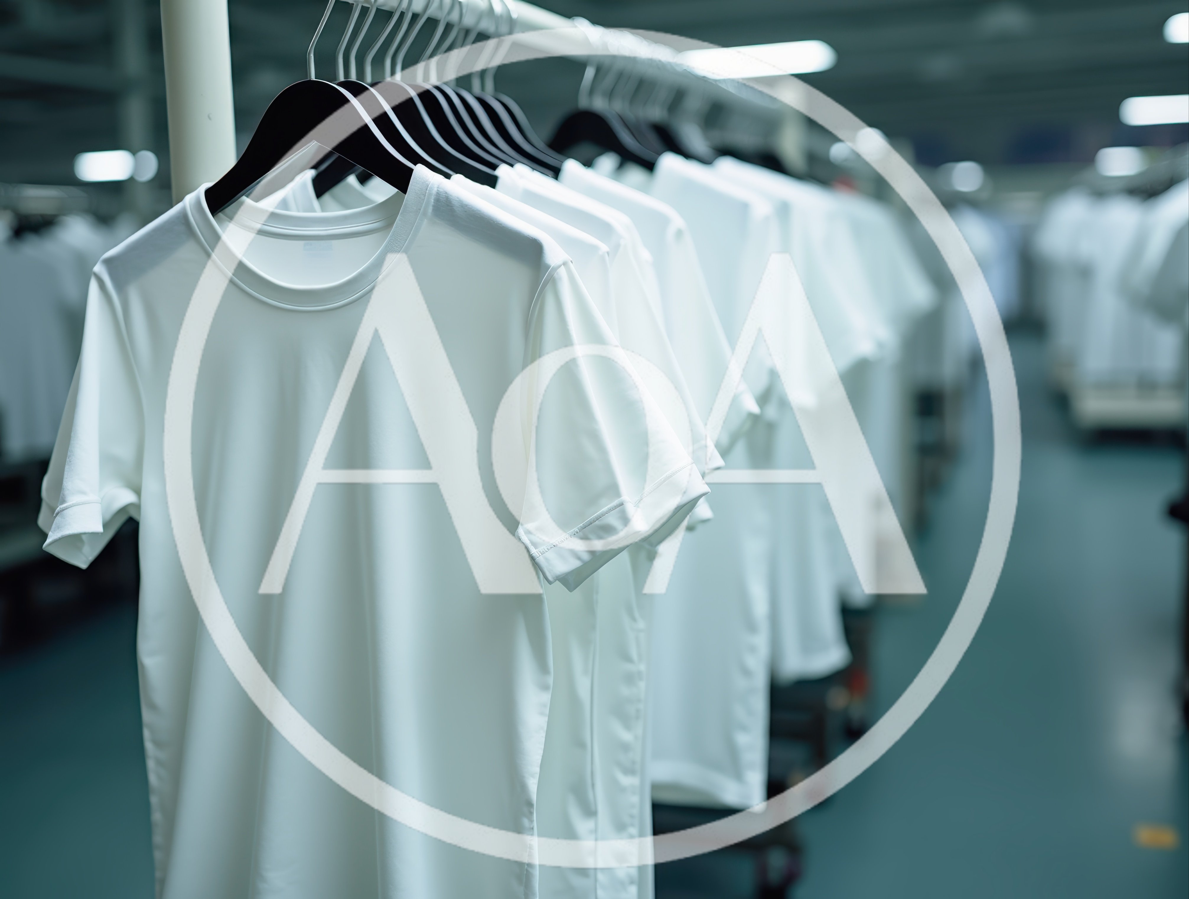 Rows Of White T-Shirts Hanging On A Clothing Rack