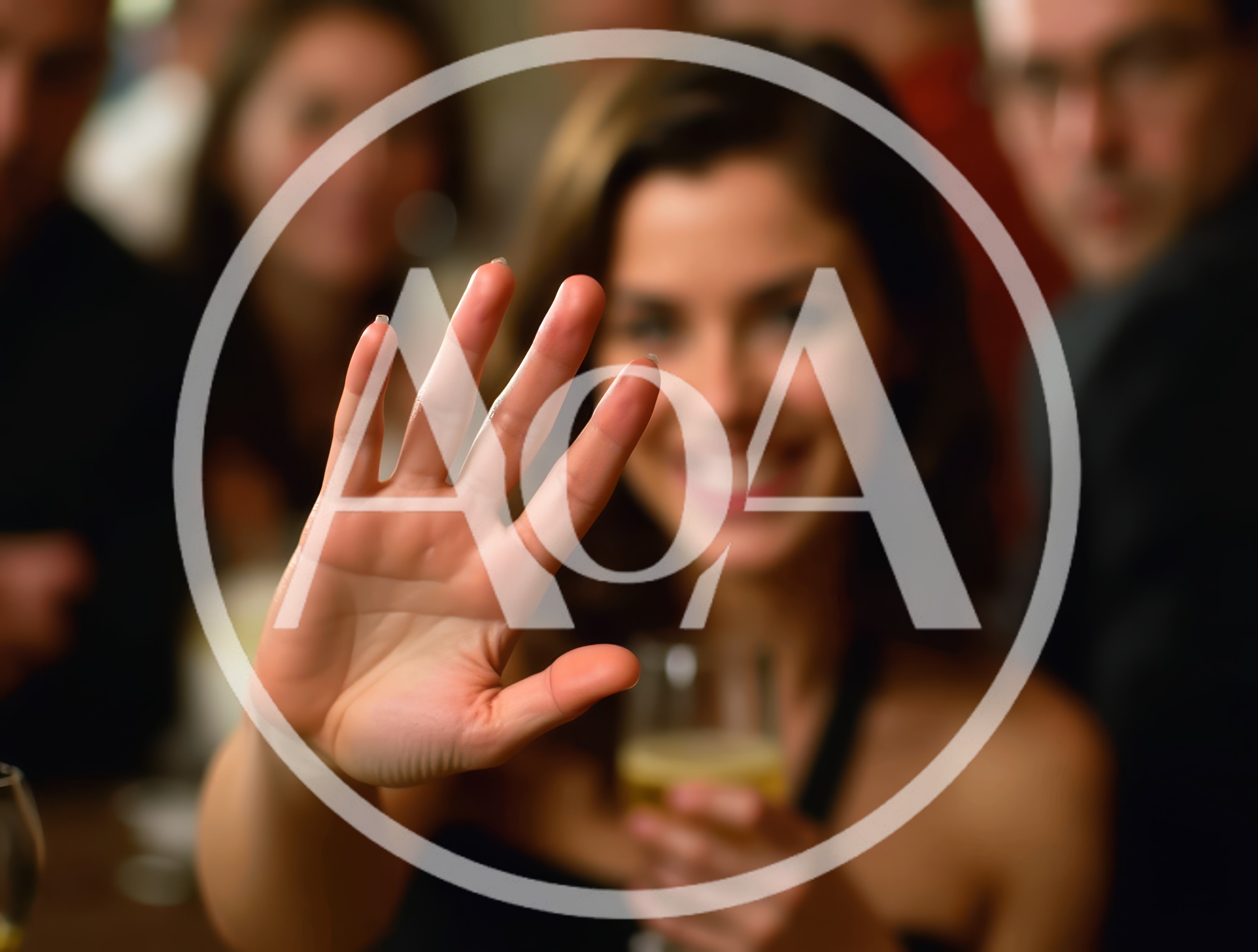 Woman Holding Up Hand In A Social Gathering