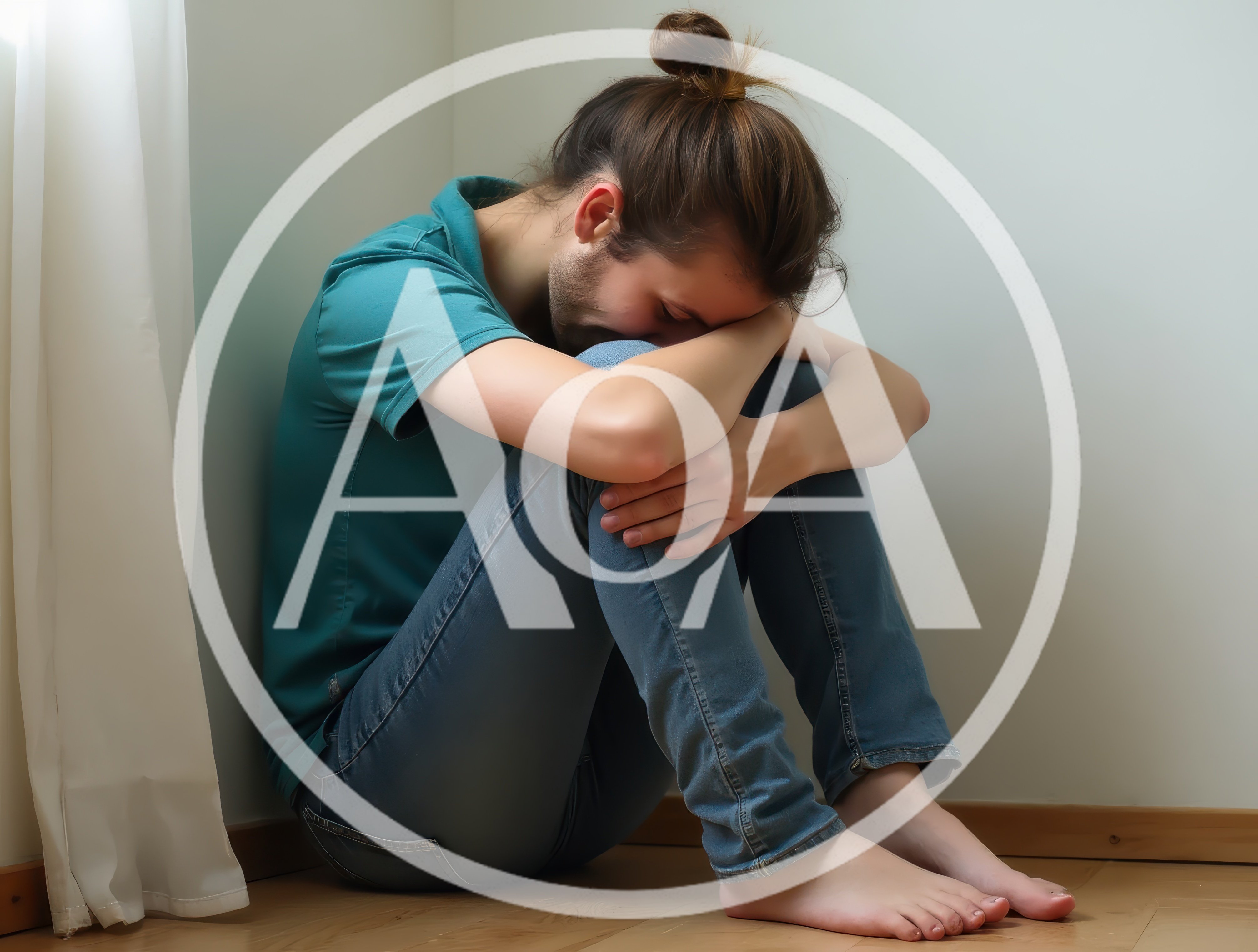 Young Man Sitting Alone In Corner Feeling Depressed
