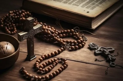Religious Objects Including Rosary Beads And A Cross