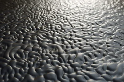 Abstract Dark Liquid Surface With Rippling Texture