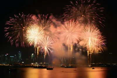 Spectacular Fireworks Display Over City Skyline At Night