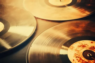 Three Vintage Vinyl Records With Warm Golden Lighting