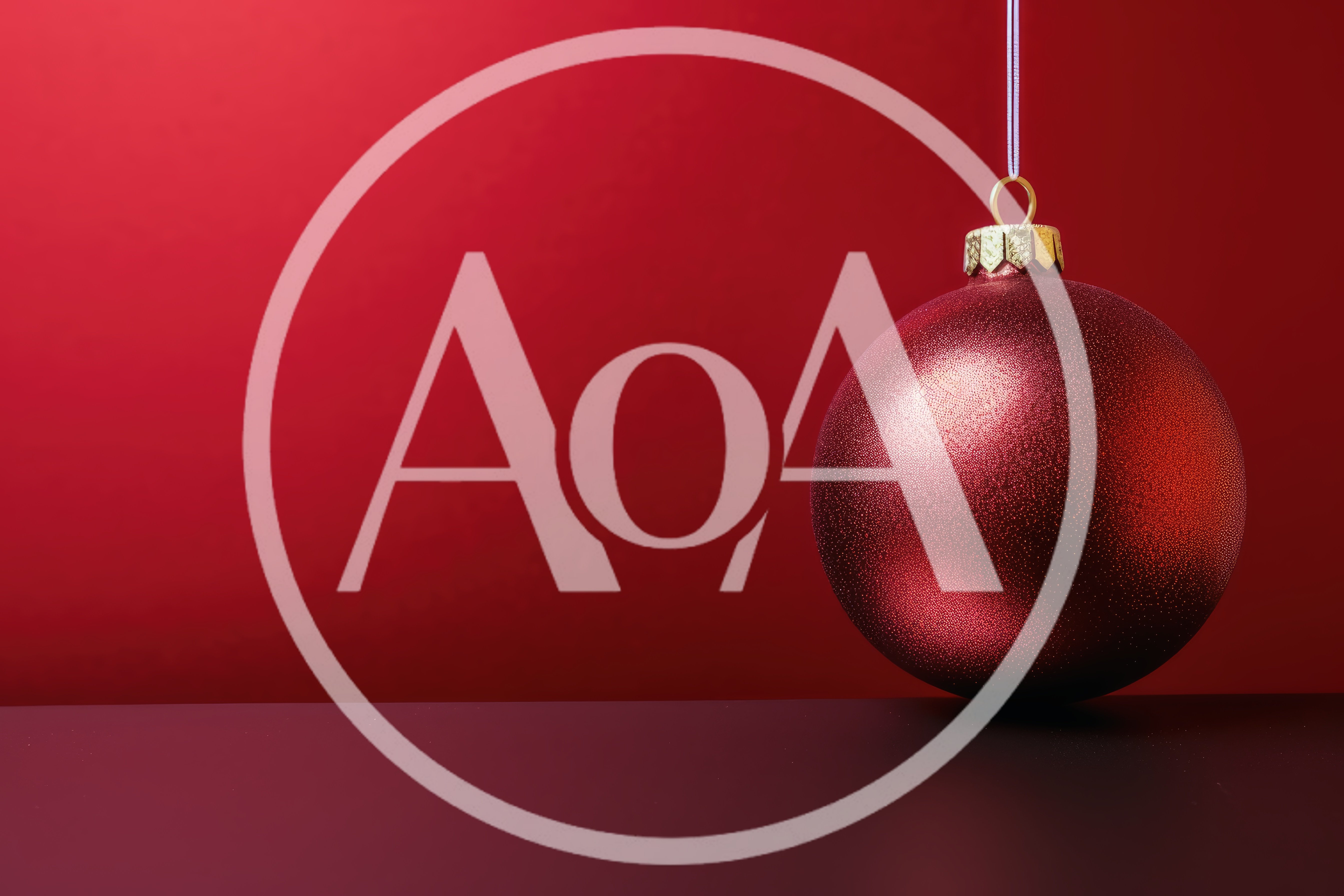 Red Christmas Ornament Hanging Against Red Background