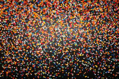 Colorful Confetti Falling Against A Dark Background