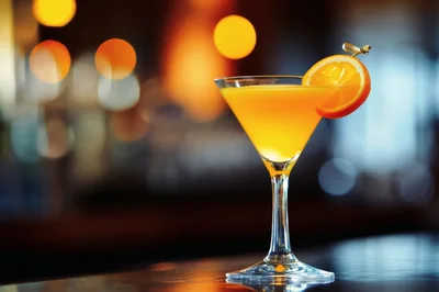 Orange Cocktail In A Martini Glass On A Bar