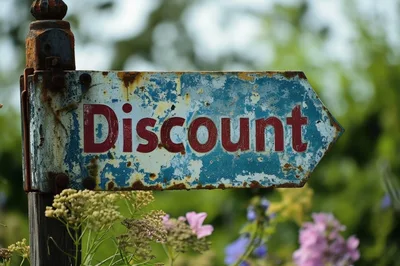 Weathered Metal Sign Pointing Towards Discount