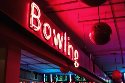 Neon Bowling Sign With Hanging Bowling Balls