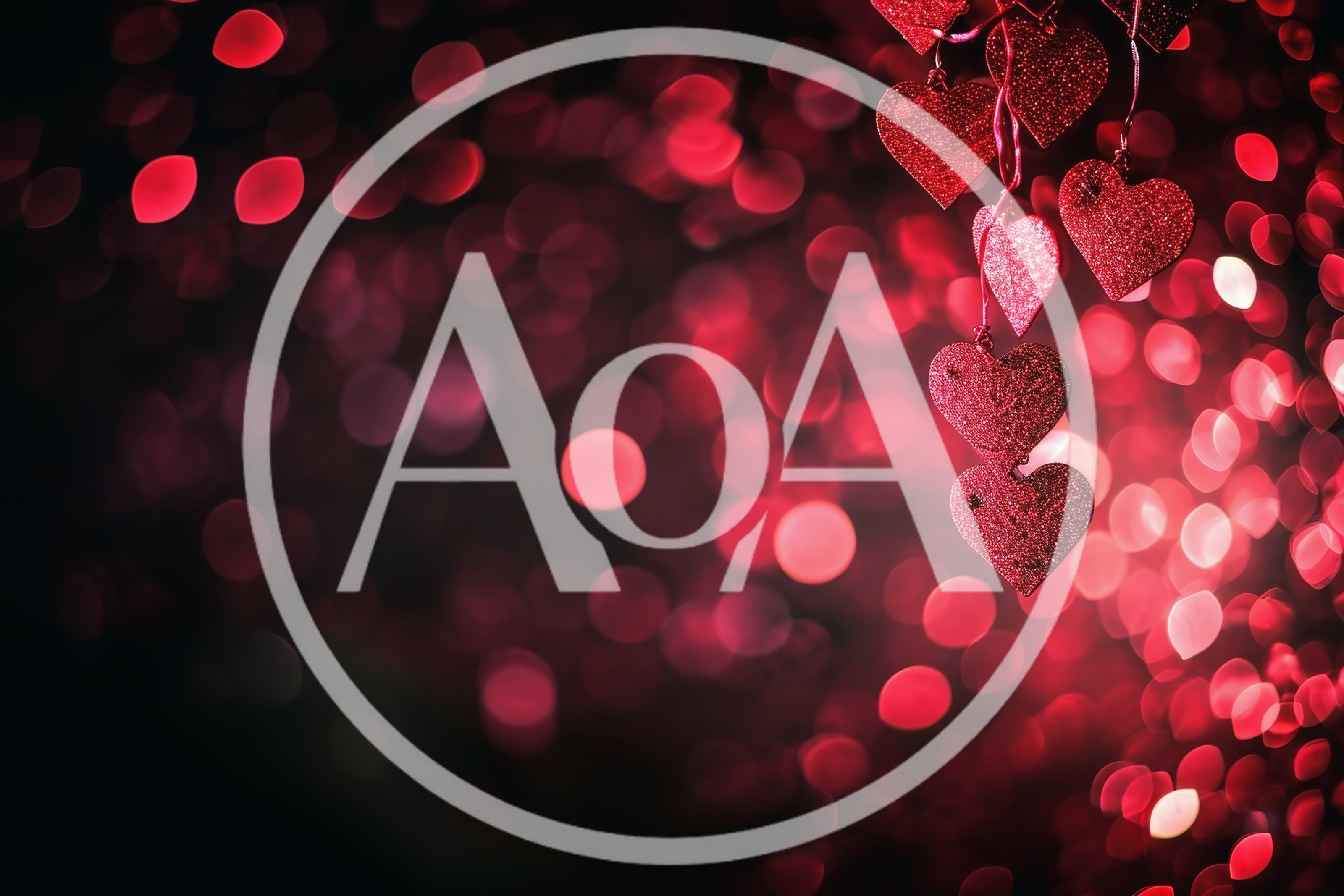 Red Glittering Heart Ornaments Hanging Against Bokeh Background