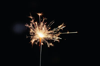 Sparkler Burning Brightly Against A Dark Background