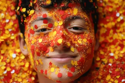 Portrait of a Young Person Covered in Colorful Confetti