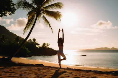 Woman Practicing Tree Pose Yoga On Tropical Beach