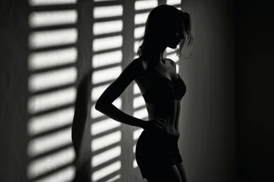 Silhouette Of A Fit Woman Posing In Dramatic Lighting