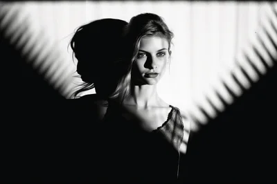 Portrait Of A Young Woman With Dramatic Shadow Lighting