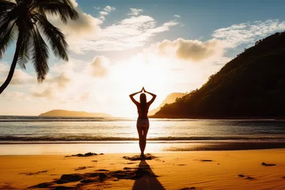Woman Practicing Yoga Pose On Tropical Beach At Sunset