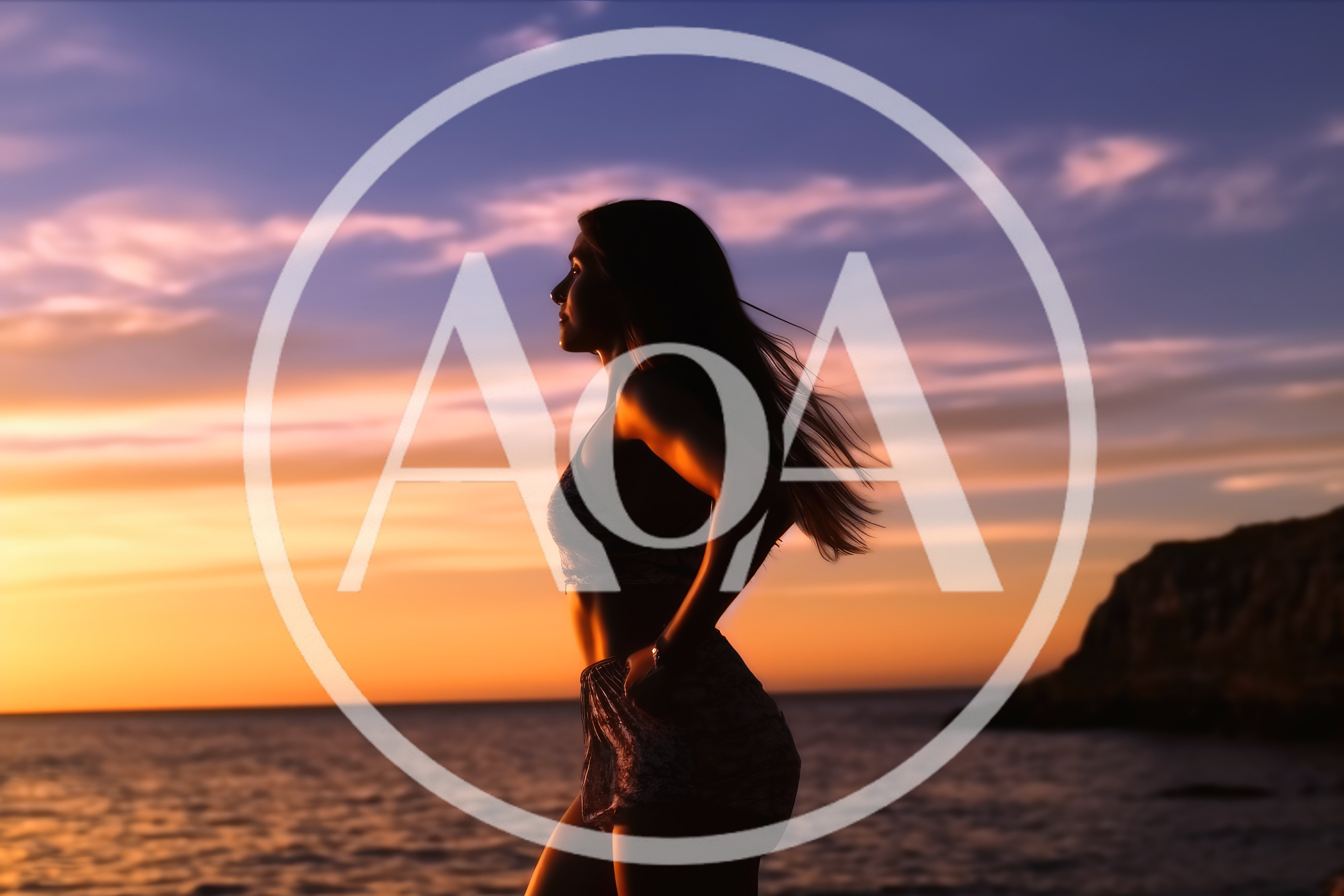 Silhouette of a Woman Standing on the Beach at Sunset