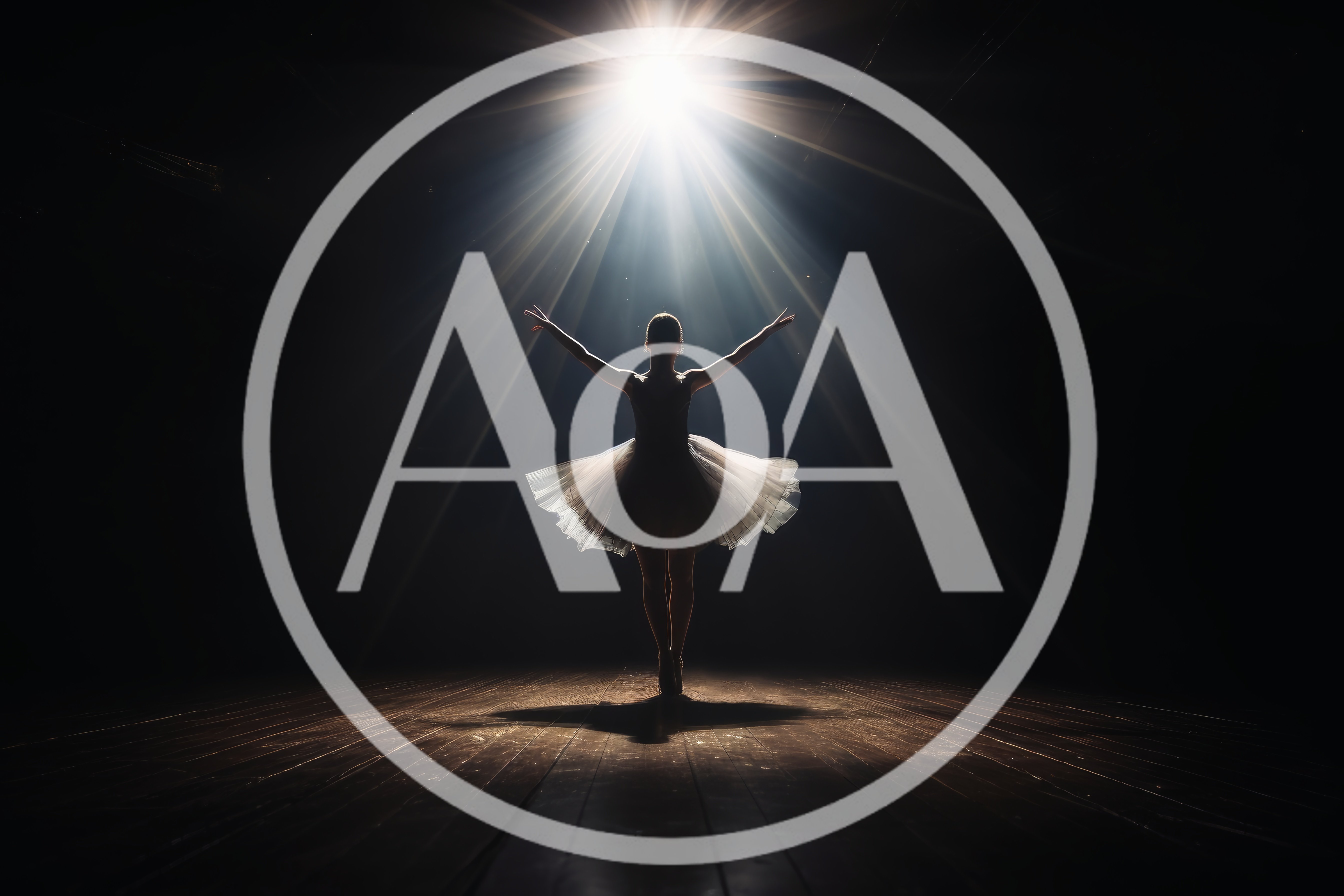 Ballerina Performing Under Dramatic Spotlight On Stage